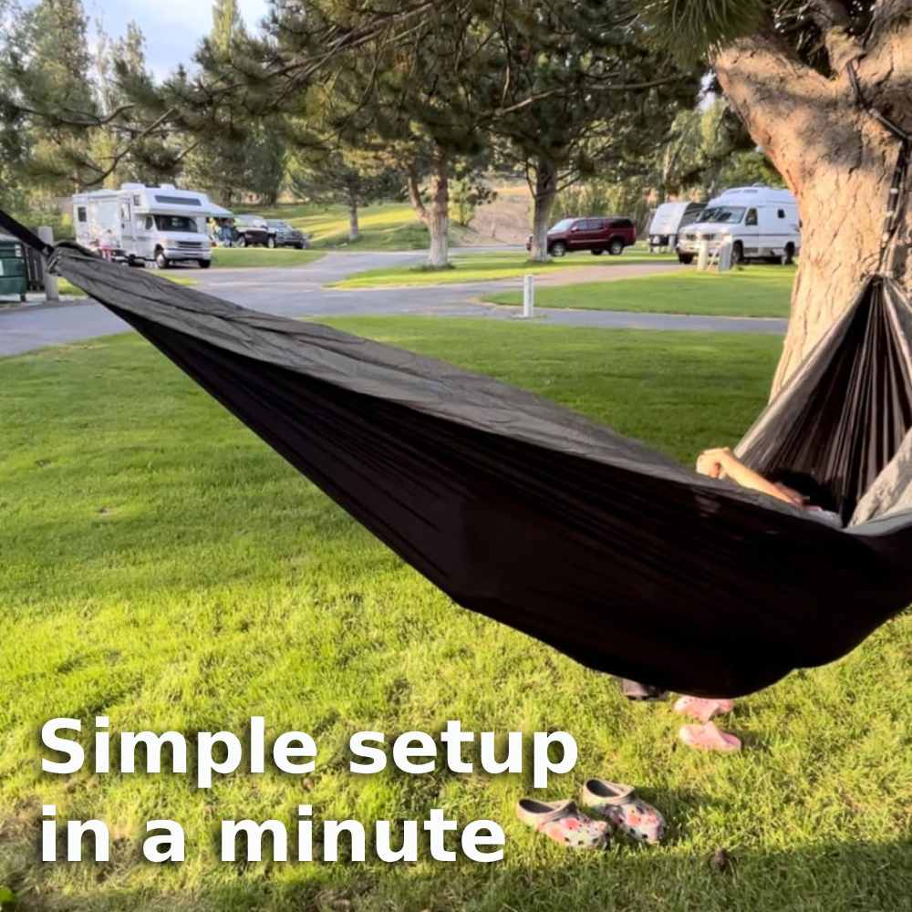 A parachute nylon camping hammock slung between two trees